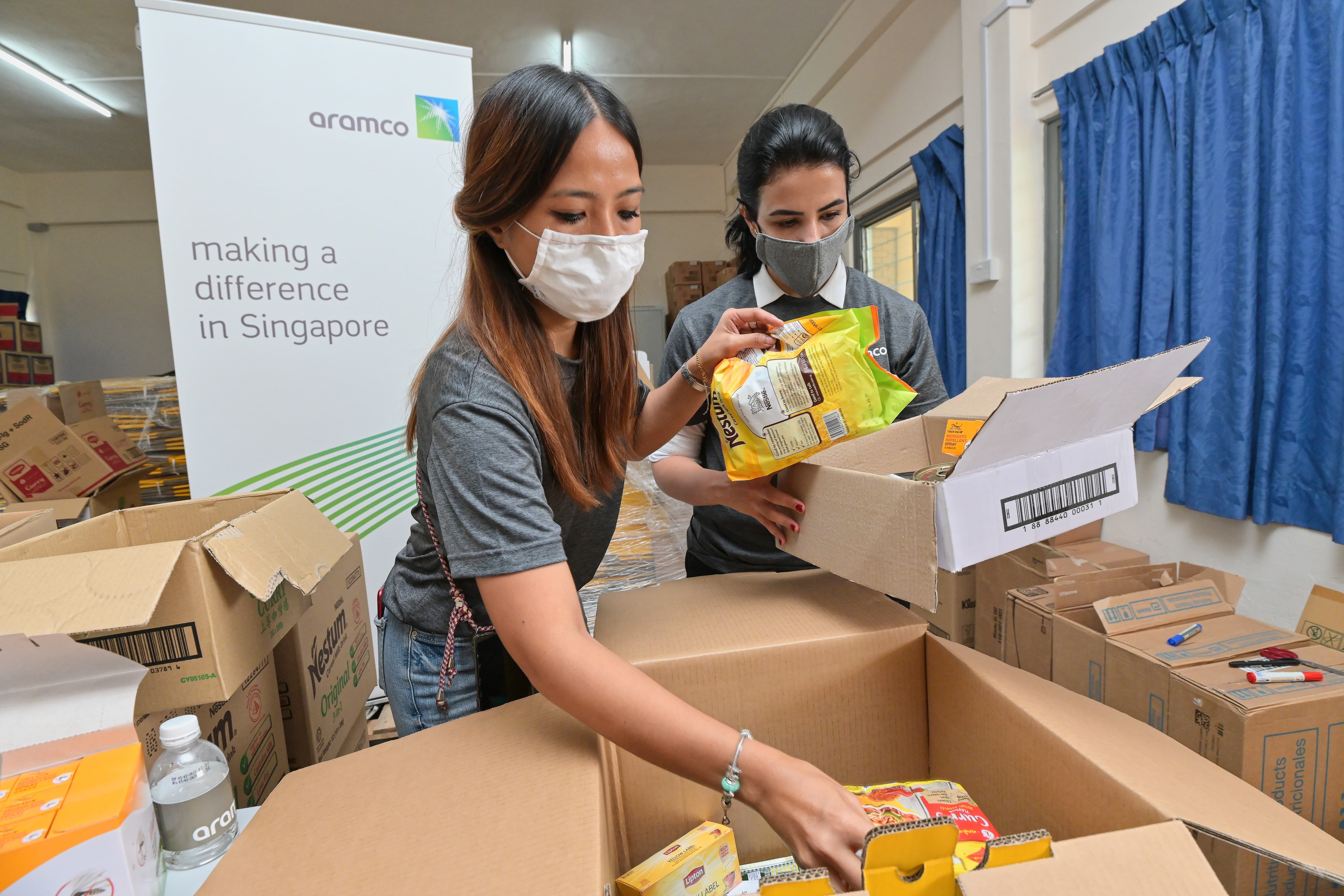 AAS MD MAK with employee packing care packages
