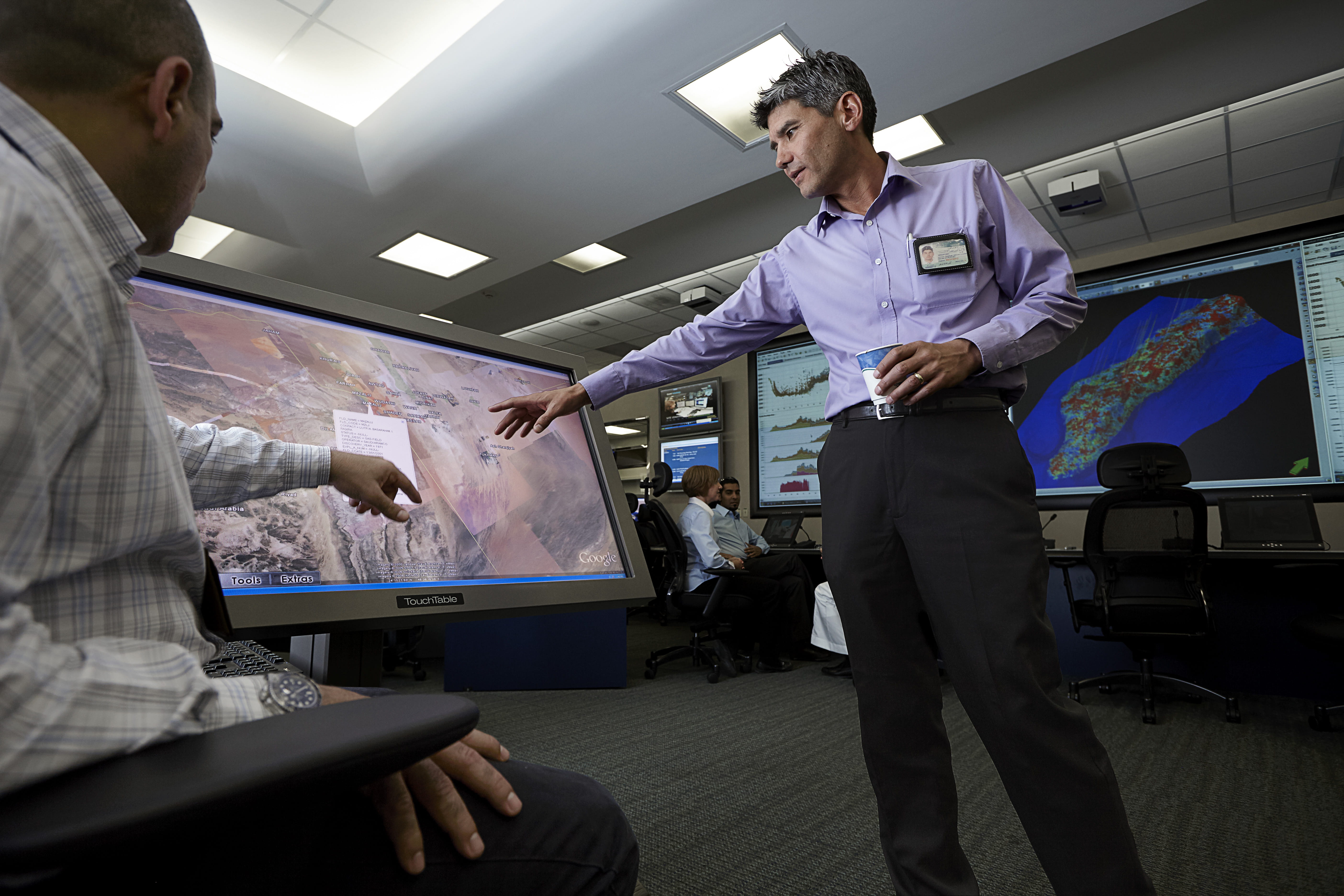 Gentlemen pointing at a screen