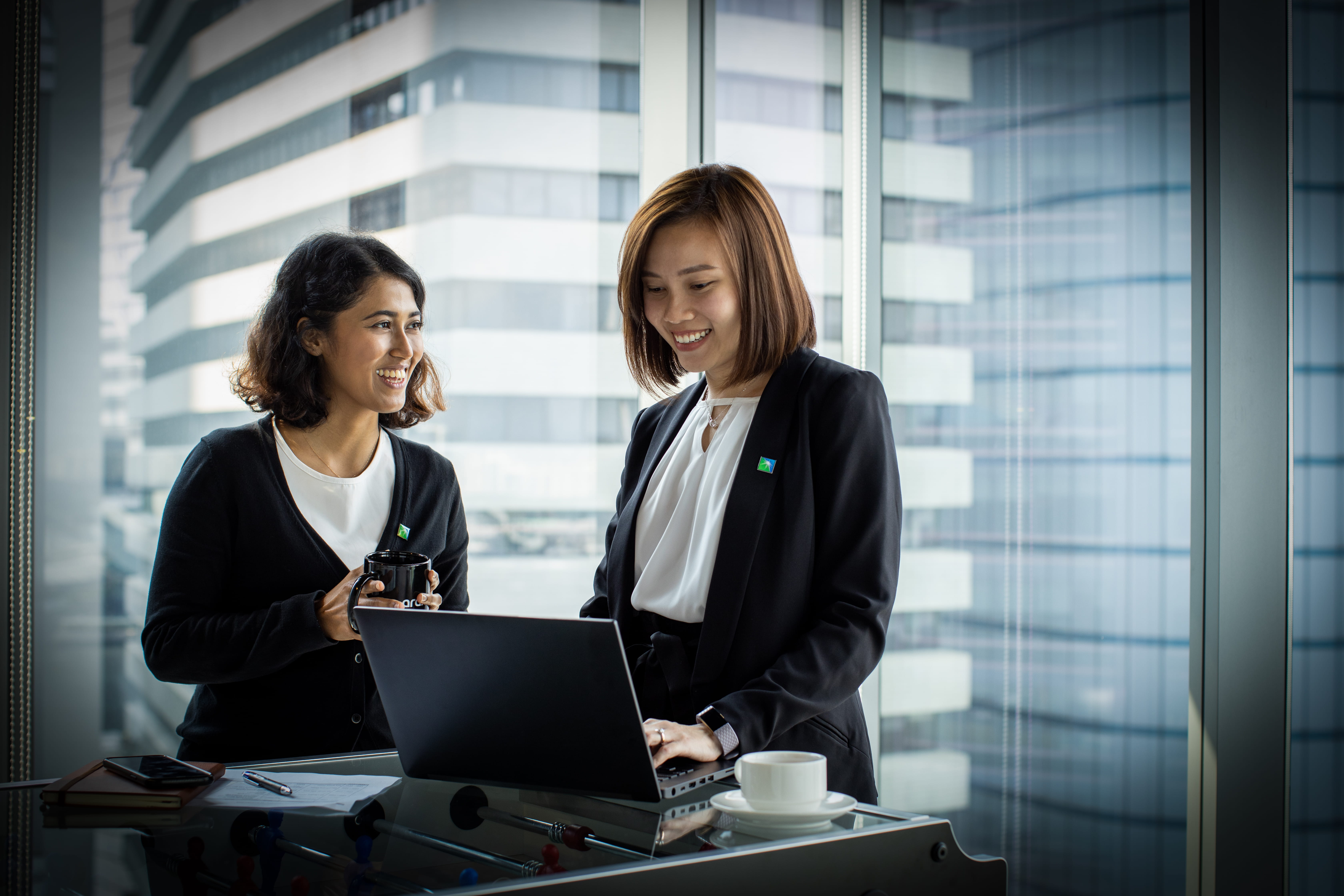 Two local ladies on laptop smiling