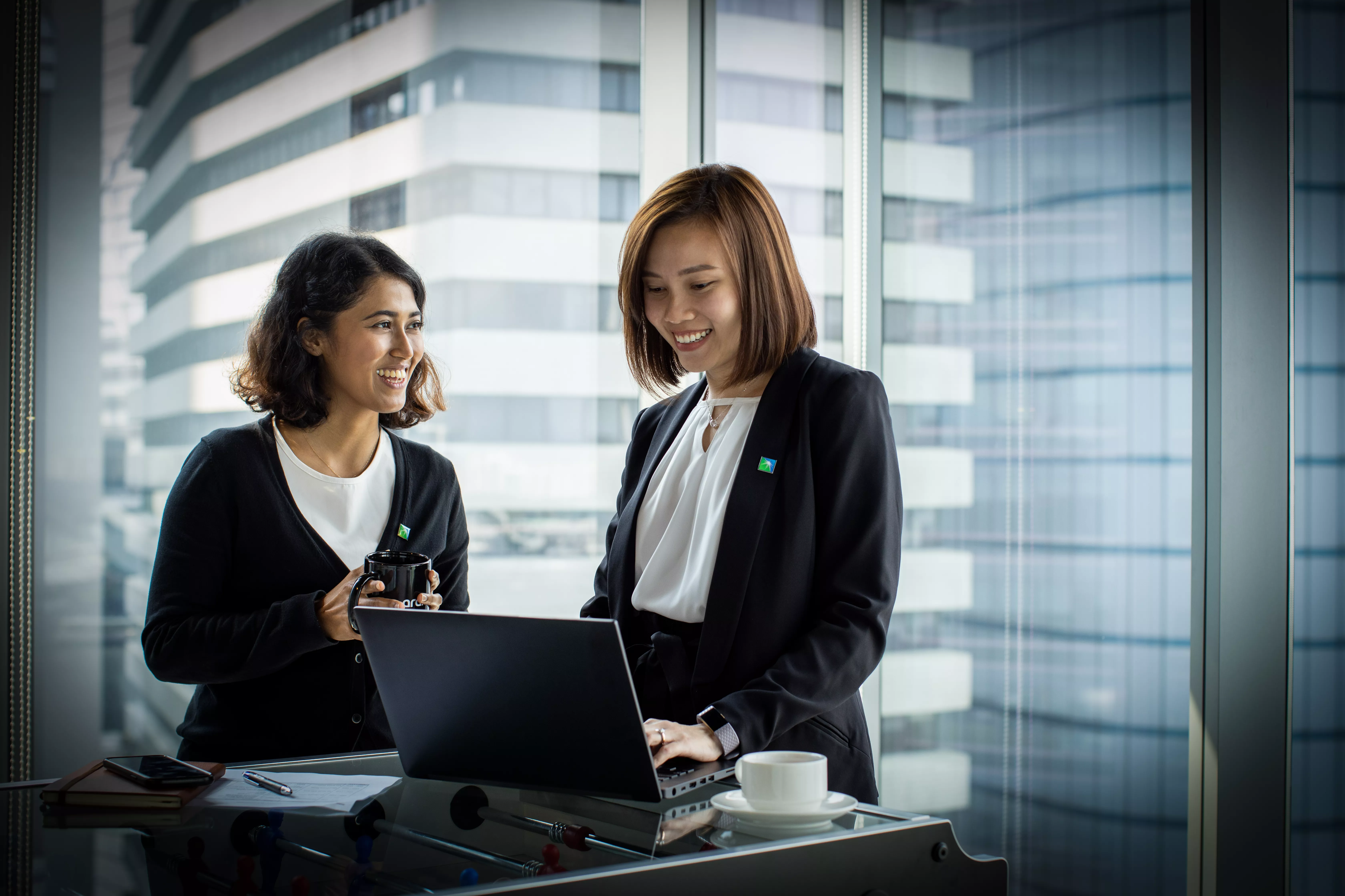 Two local ladies on laptop smiling