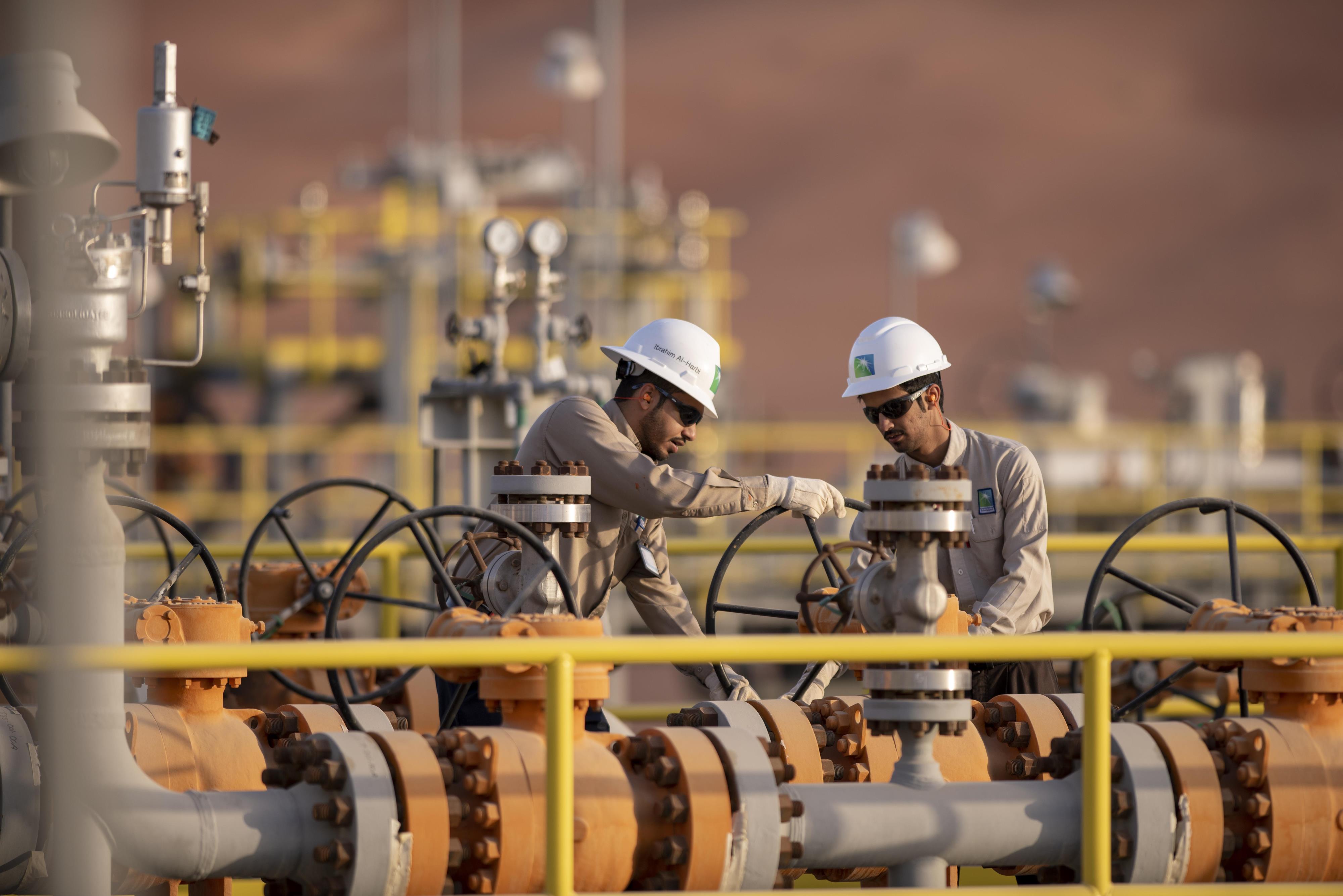 Two workers in hard hats at Shaybah facility