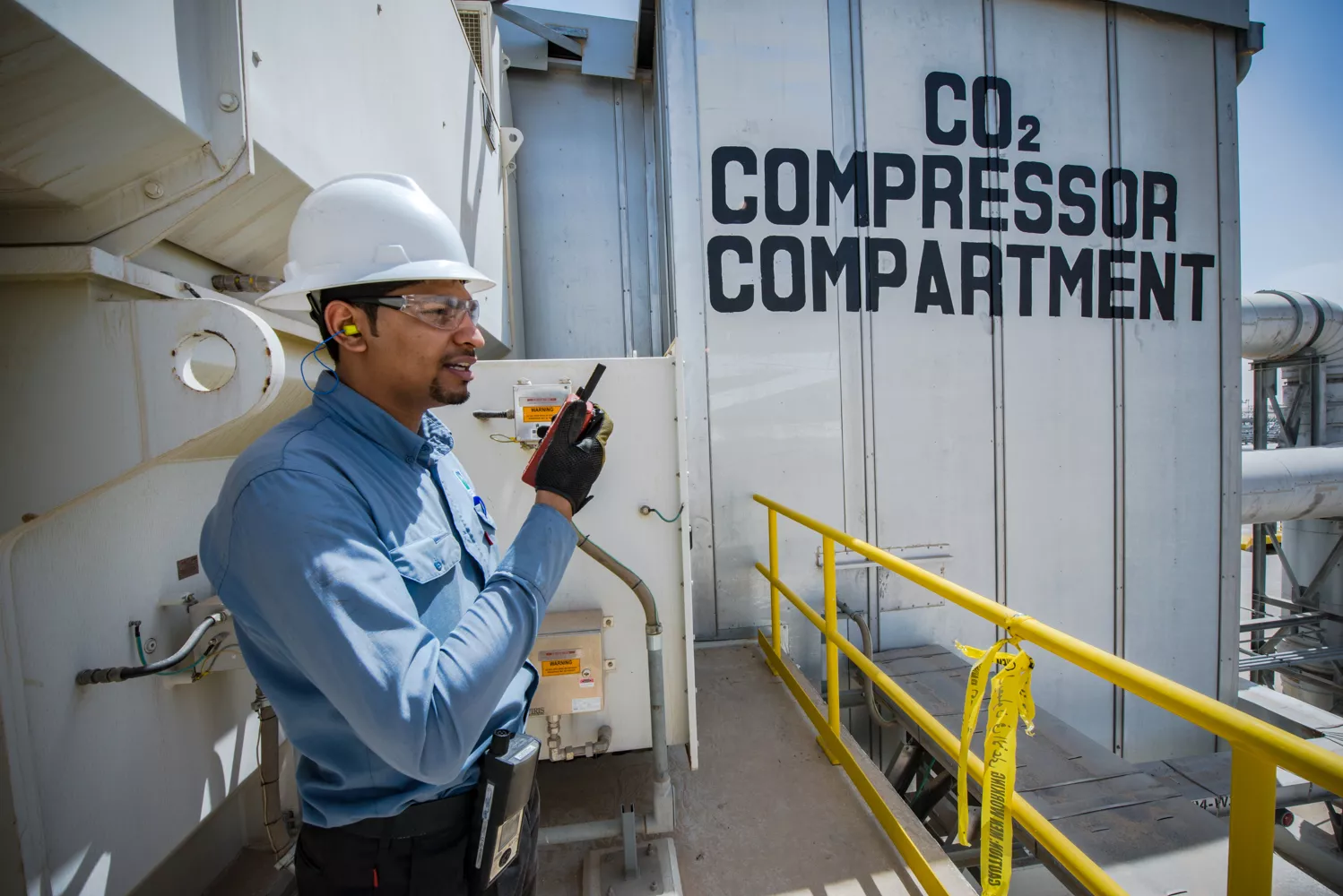 Saudi Aramco engineer communicating at production facility